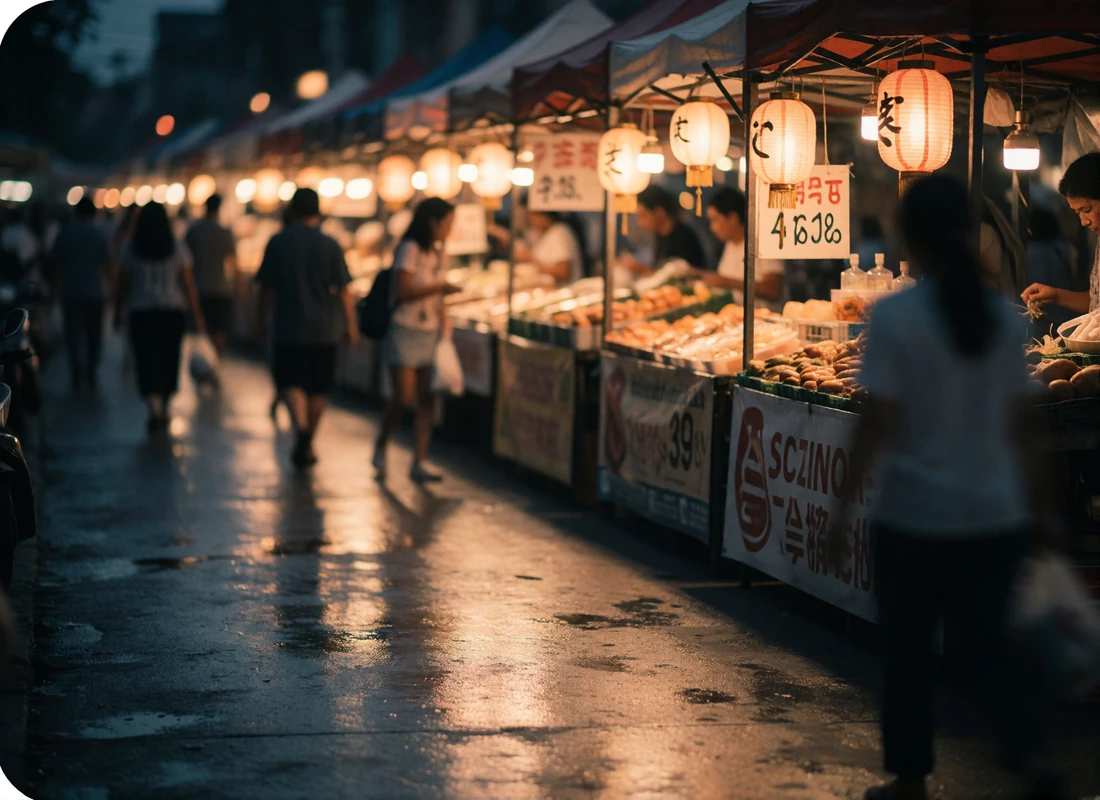 Lantern-lit Southeast Asian night market street at dusk with soft bokeh in the distance