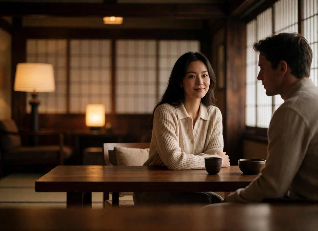 Couple seated across a low wooden table inside a refined tea house, both in understated neutral clothing